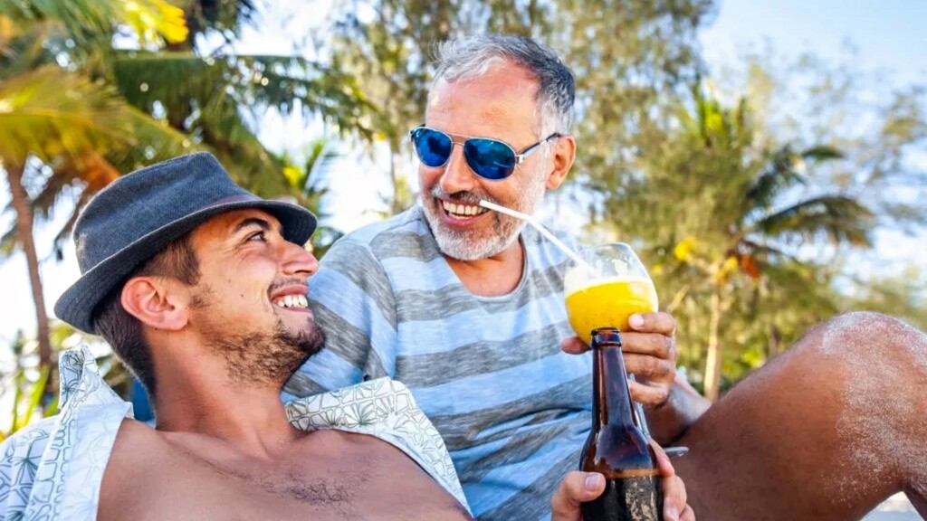 gay sugar daddy with male sugar baby on beach